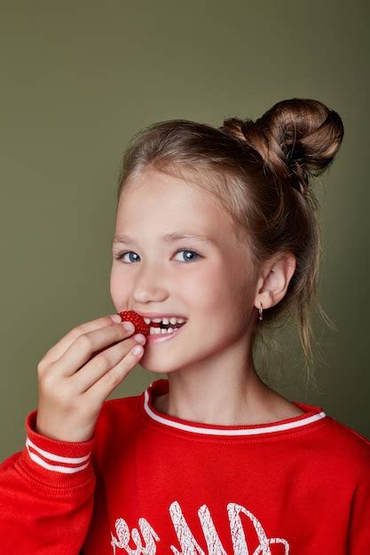 Premium Photo Young Girl Eats Strawberries Bright Cheerful Emotions On The Girls Face Juicy