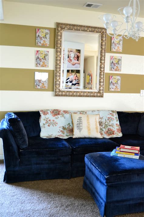 From furniture to home decor, we have everything you need to create a stylish space for your family and friends. gold stripes on wall, navy couch | Navy couch, Home decor