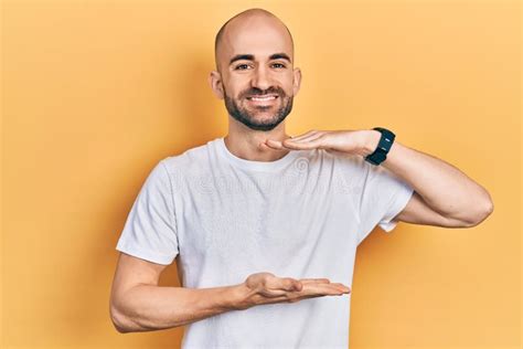 Young Bald Man Wearing Casual White T Shirt Gesturing With Hands