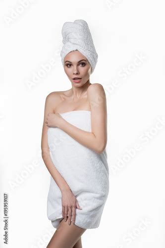 Portrait Of Shy Girl Standing Wrapped By White Bathing Towel She Is