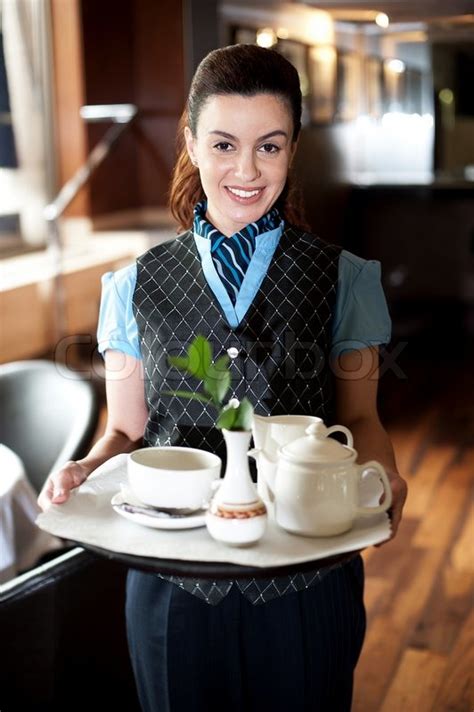 Profile Shot Of A Cheerful Female Waitress Stock Photo Colourbox