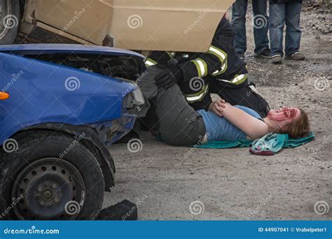 Firefighters Saving The Bleeding Woman From A Crashed Car Editorial