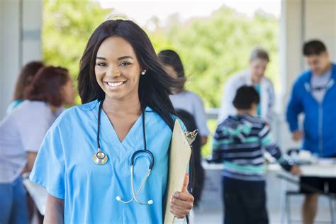 Smiling African American Nurse With A Clipboard And Stethoscope High