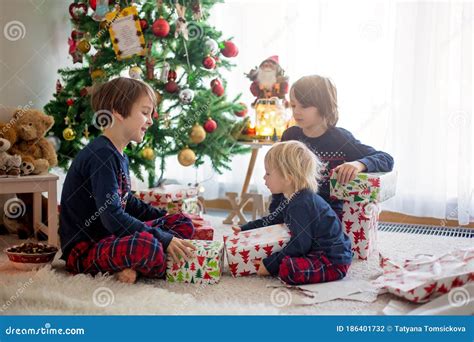 Happy Children Opening Presents On Christmas Day Stock Photo Image