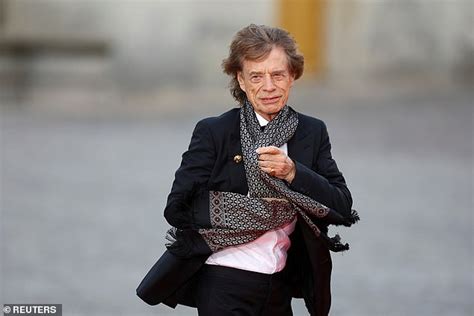 sir mick jagger 80 battles strong winds as he arrives at king charles and queen camilla s