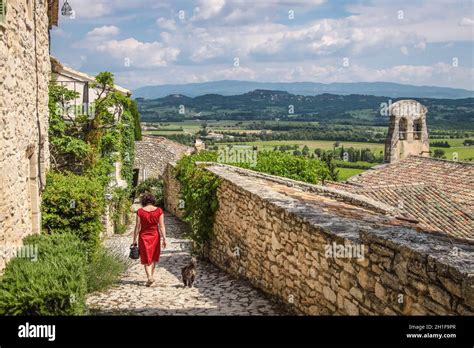 Young Woman With Red Dress In The Village Of Joucas In Provence France