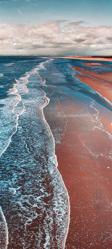 287958 Crystal Blue Waves Coming In Onto A Sandy Beach Coastline