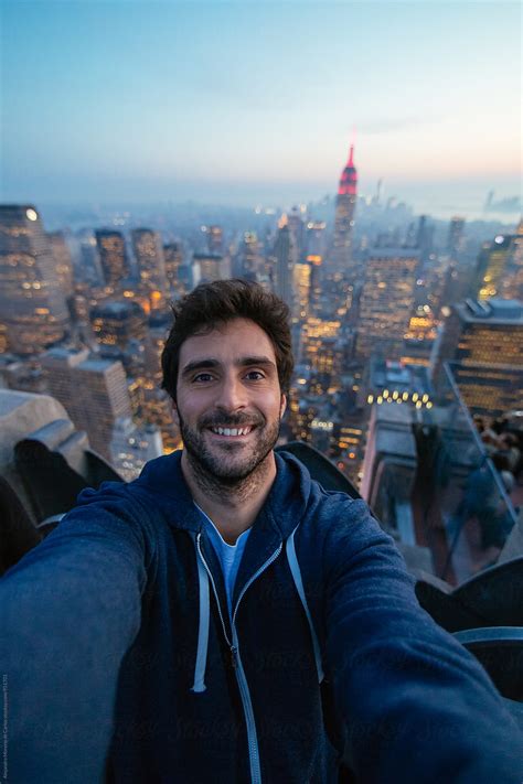 Young Man Taking A Selfie On A Rooftop With The View Of New York City