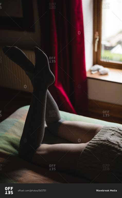 Woman Lying On Bed In Bedroom Stock Photo Offset