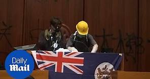 Protestors unveil British colonial flag in Hong Kong legislature
