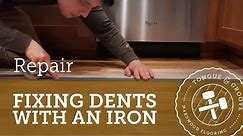 Repairing dents in a hardwood floor with an iron