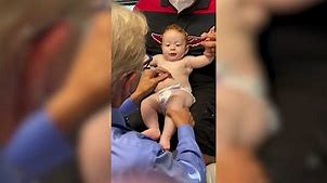Doctor makes baby giggle during shots