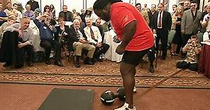 Mark Henry attempts to lift the legendary Thomas Inch Dumbbell with one hand (WWE Network)