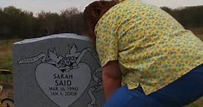Patricia Owens visiting Amina and Sarah's headstone