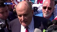 Rudy Giuliani speaks to press as he surrenders in GA election case
