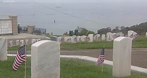 Volunteers honor fallen service members at Fort Rosecrans with a flag