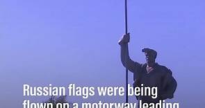 Russian flags flown on motorway leading into Mariupol