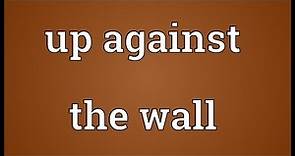 Up against the wall Meaning