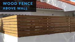 How to Install a Wood Fence Above a Wall