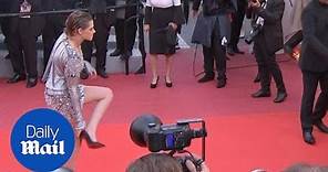 Kristen Stewart poses in metallic dress before taking her heels off