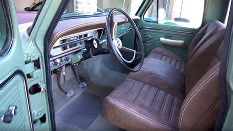 Interior view of a 1971 Ford F-100 pickup truck, showcasing the dashboard and seating.