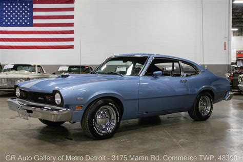 Interior view of a 1974 Ford Maverick dashboard and seats, highlighting its classic design