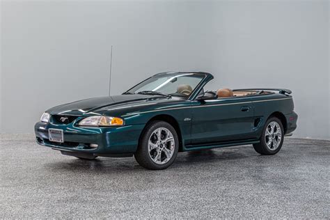 A 1996 Ford Mustang GT Convertible in white, highlighting the smoother, more rounded design of the SN95 generation