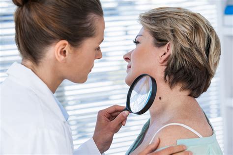 A dermatologist examining a patient's hair.