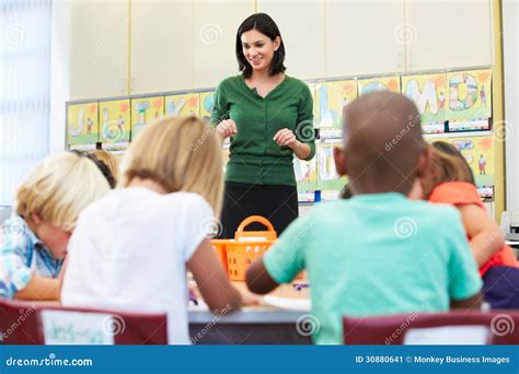Two teachers talking in a school hallway