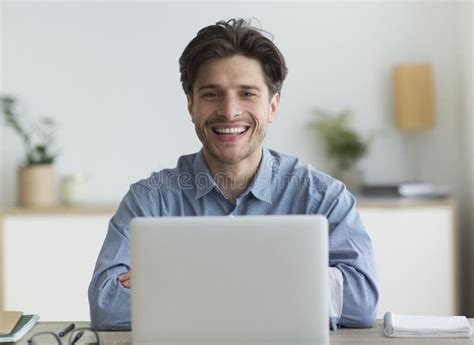 Mixed race short-haired man Sitting in the office smiling looking at camera