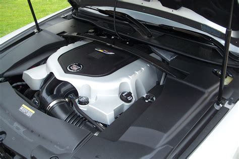 Car engine with cover off showing engine sensor