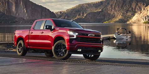 A Chevrolet Silverado pickup truck driving on a scenic highway, highlighting its performance capabilities.