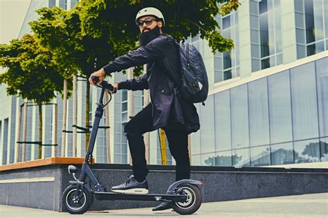 person riding electric scooter with headphones